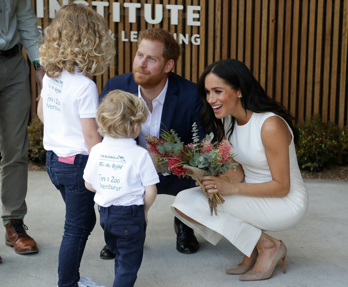 11 Pics Of Prince Harry & Meghan Markle Talking To Kids That Prove They