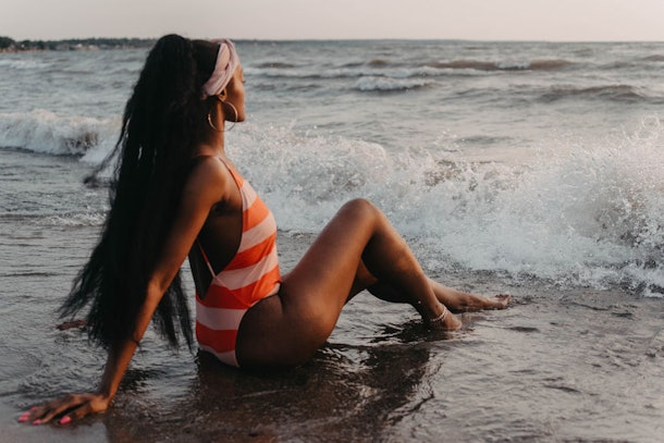 This woman in a striped bathing suit on the beach might dress up like a 'Bachelor in Paradise' contestant for Halloween.