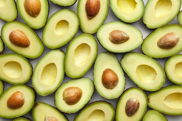 A bunch of avocados on a table can be inspiration for your clever Halloween costume that's totally on trend.