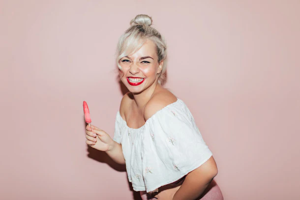 This woman holding a pink popsicle has the perfect look for an ice cream cone Halloween costume.