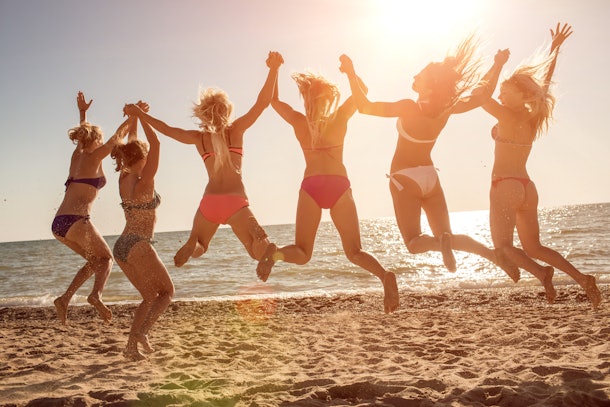 284e4f76-87e5-4232-8b91-1d74f71eda54-friends_jumping_beach.jpg?w=610&fit=max&auto=format&q=70