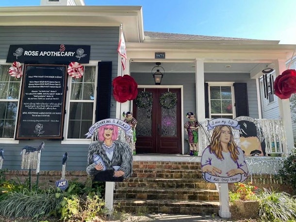 A house decorated like 'Schitt's Creek' for Mardi Gras has a Moira Rose and Alexis Rose cutout in the front. 
