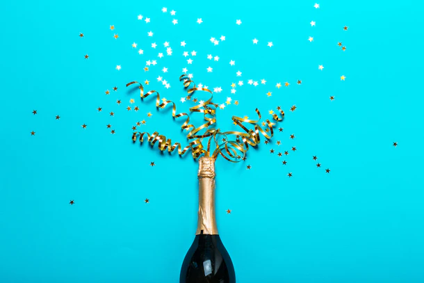 Champagne bottle with colorful party streamers