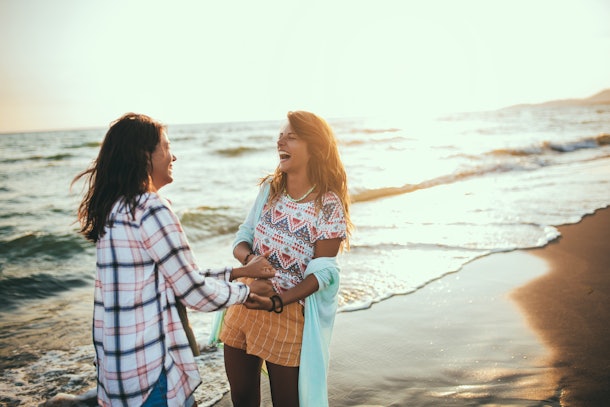 Pretty girl has a fun with her girlfriend on the beach