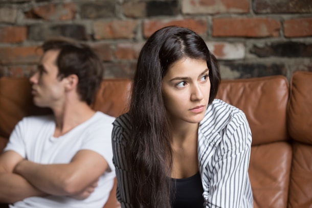Angry unhappy young couple ignoring not looking at each other after family fight or quarrel, upset thoughtful spouses avoiding talk, sitting silently on couch, having relationship troubles.