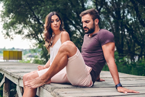 Couple fighting while sitting on the pier