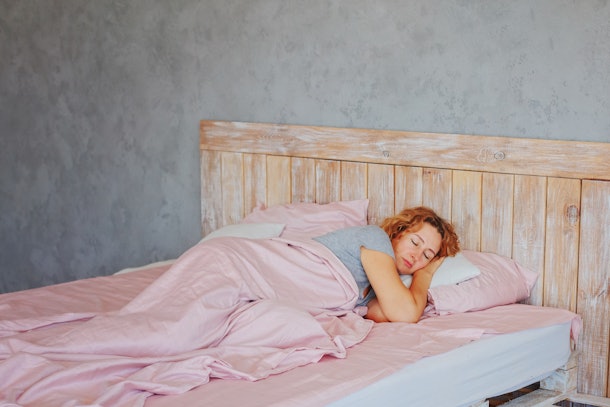Insomnia in women during menopause / Overwork and early ascents/ Middle-aged woman sleeping asleep in bed / copy space