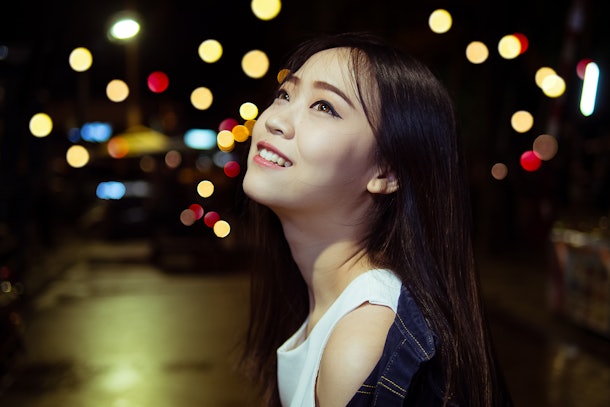 cute asian girl in the night light city with bokeh happiness emotions